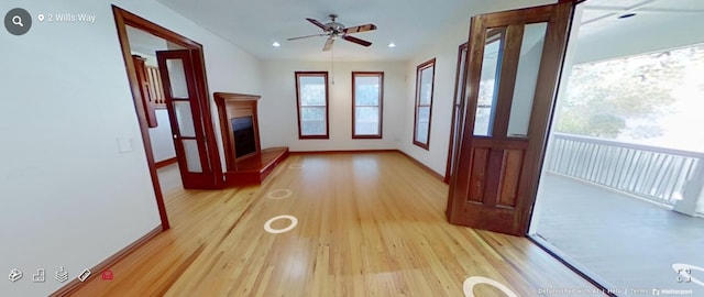 hallway with recessed lighting, light wood-style floors, and baseboards