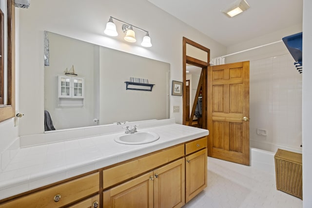 bathroom with shower / bathing tub combination, tile patterned flooring, and vanity