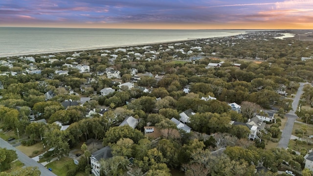 aerial view at dusk featuring a water view