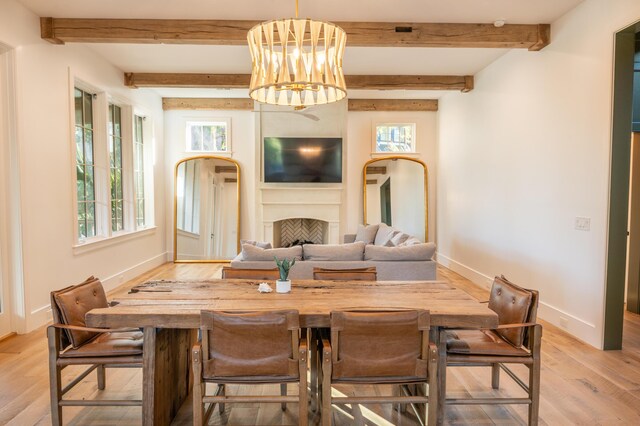 515 Claret Way, Kiawah Island, SC 29455 - dining space featuring light wood-style floors, baseboards, a fireplace, a chandelier, and beamed ceiling