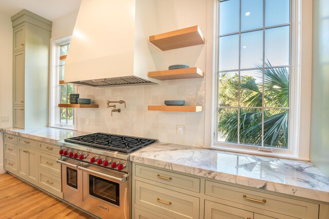 515 Claret Way, Kiawah Island, SC 29455 - kitchen featuring custom exhaust hood, double oven range, open shelves, decorative backsplash, and light stone countertops
