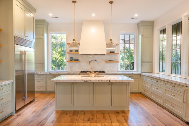 515 Claret Way, Kiawah Island, SC 29455 - kitchen featuring built in refrigerator, custom range hood, open shelves, tasteful backsplash, and light stone countertops