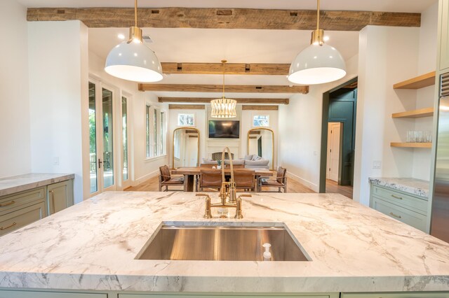 515 Claret Way, Kiawah Island, SC 29455 - kitchen with a sink, open floor plan, beam ceiling, light stone counters, and wood finished floors