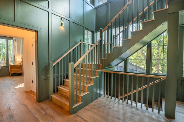 515 Claret Way, Kiawah Island, SC 29455 - stairs with wood finished floors, plenty of natural light, a decorative wall, and a high ceiling