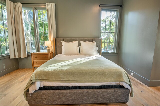 515 Claret Way, Kiawah Island, SC 29455 - bedroom featuring multiple windows, wood finished floors, and baseboards