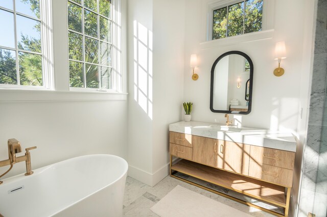 515 Claret Way, Kiawah Island, SC 29455 - full bathroom featuring healthy amount of natural light, vanity, marble look tile flooring, and baseboards