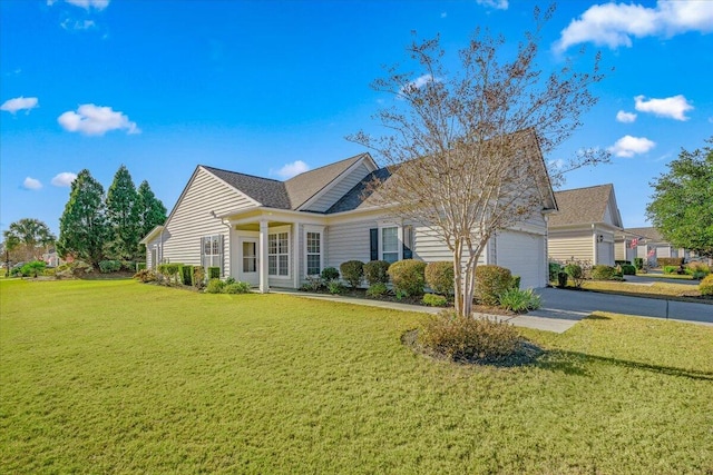 view of front of property with a garage and a front lawn