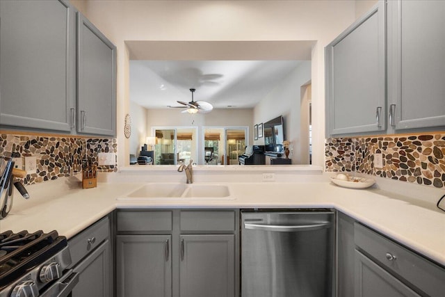 kitchen featuring sink, dishwasher, ceiling fan, gray cabinetry, and tasteful backsplash