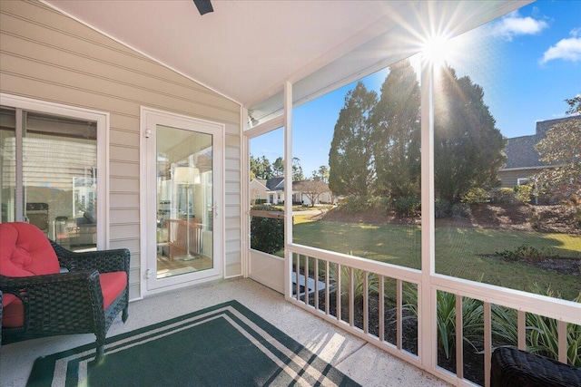 sunroom featuring vaulted ceiling