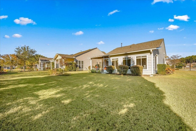 back of house featuring a lawn