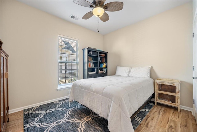 bedroom with hardwood / wood-style floors and ceiling fan