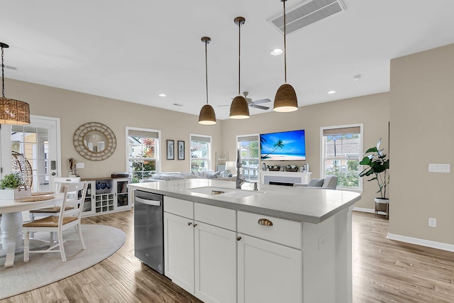 2961 Waterleaf Rd, Johns Island, SC 29455 - kitchen featuring stainless steel dishwasher, a sink, wood finished floors, white cabinetry, and recessed lighting