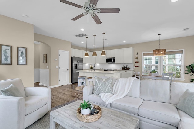 2961 Waterleaf Rd, Johns Island, SC 29455 - living area with arched walkways, wood finished floors, a ceiling fan, baseboards, and recessed lighting