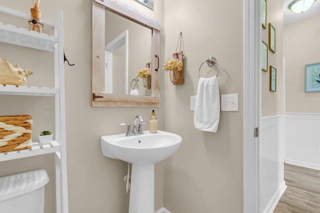 2961 Waterleaf Rd, Johns Island, SC 29455 - half bath with wood finished floors, a wainscoted wall, toilet, and a sink