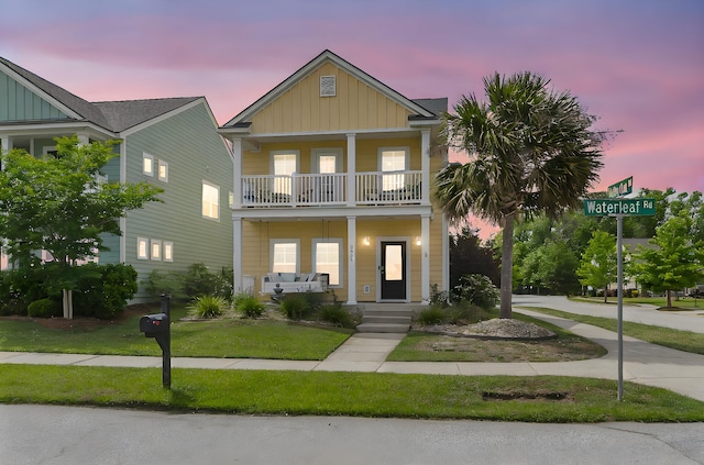 2961 Waterleaf Rd, Johns Island, SC 29455 - view of front facade featuring board and batten siding, a porch, a front yard, and a balcony