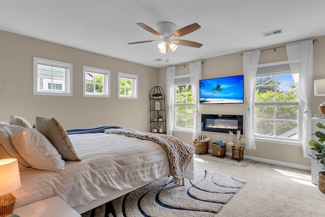 2961 Waterleaf Rd, Johns Island, SC 29455 - bedroom with carpet floors, baseboards, a glass covered fireplace, and ceiling fan