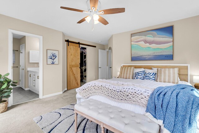 2961 Waterleaf Rd, Johns Island, SC 29455 - bedroom featuring light colored carpet, a barn door, baseboards, a spacious closet, and connected bathroom
