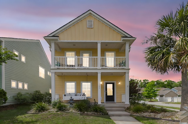 2961 Waterleaf Rd, Johns Island, SC 29455 - view of front facade with a balcony, covered porch, and board and batten siding