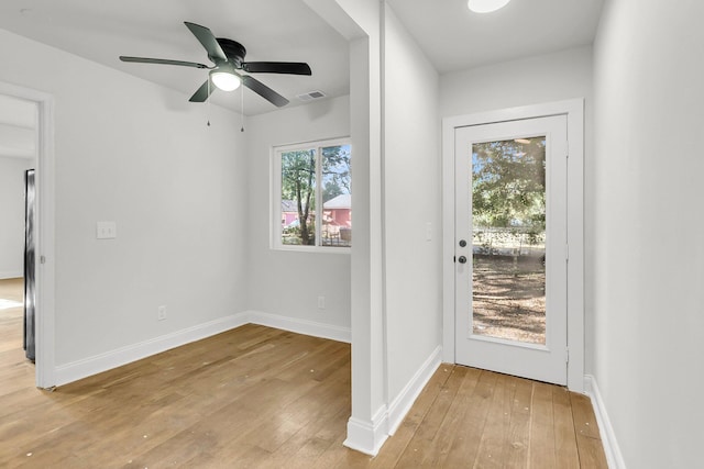 doorway featuring ceiling fan and light hardwood / wood-style floors