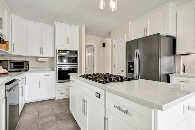 8346 Chisolm Plantation Rd, Edisto Island, SC 29438 - kitchen featuring appliances with stainless steel finishes, white cabinets, and a kitchen island