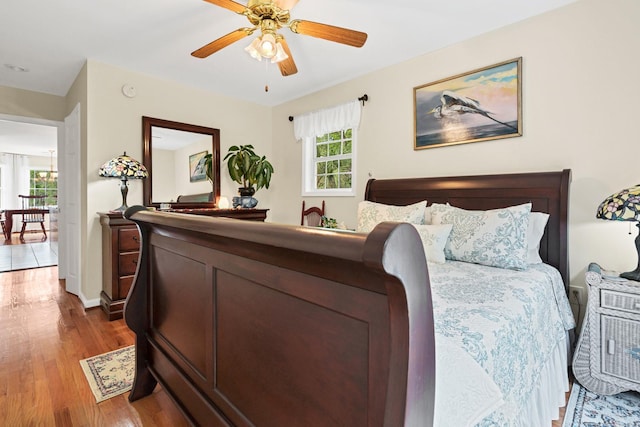 8346 Chisolm Plantation Rd, Edisto Island, SC 29438 - bedroom with wood finished floors, multiple windows, baseboards, and ceiling fan
