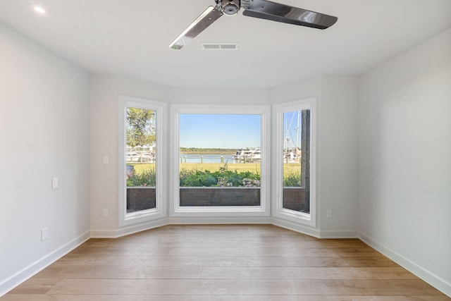 unfurnished room with ceiling fan and light hardwood / wood-style floors