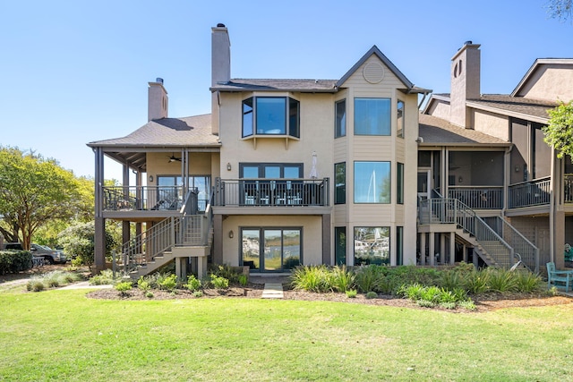 rear view of house with a yard and ceiling fan