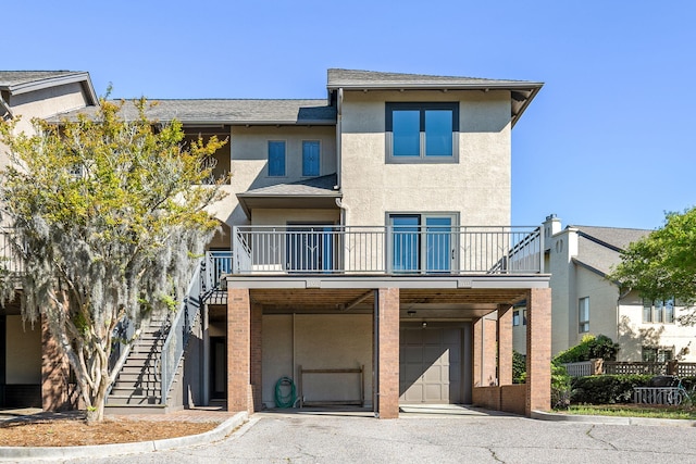 view of front of house featuring a garage and a balcony