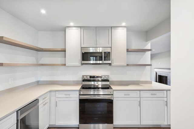 kitchen with stainless steel appliances and white cabinets