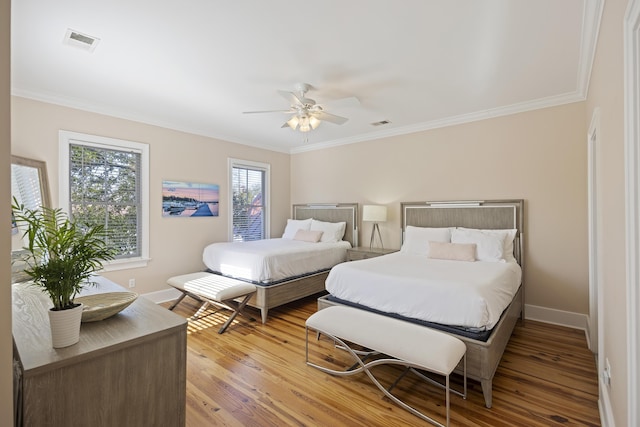 bedroom featuring crown molding, ceiling fan, and hardwood / wood-style floors