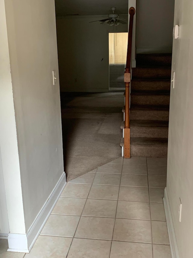 hall featuring light tile flooring