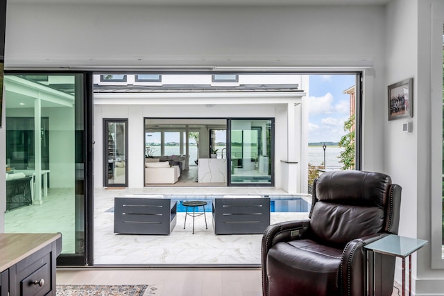 living area with wood-type flooring and a wealth of natural light