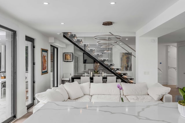 living room featuring a notable chandelier and light wood-type flooring