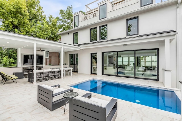 back of property featuring ceiling fan, an outdoor hangout area, and a patio area