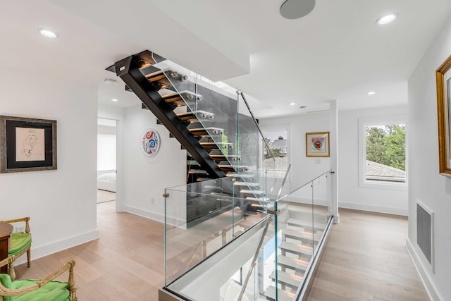 stairway featuring wood-type flooring