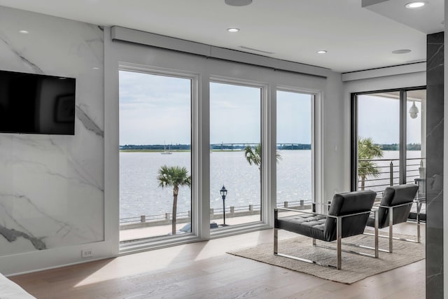 interior space with a water view and light wood-type flooring