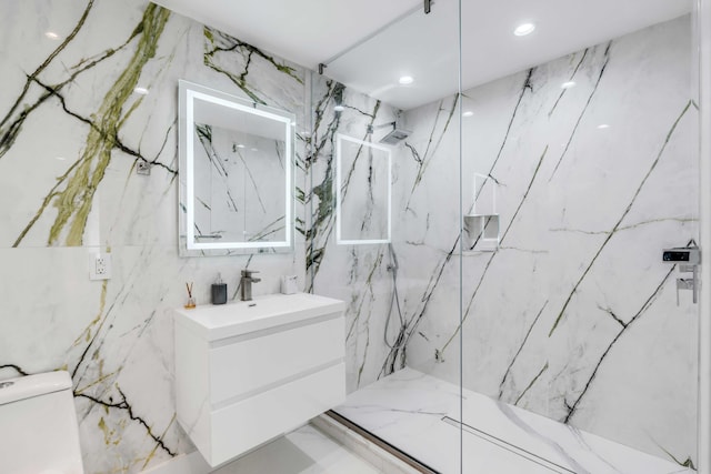 bathroom featuring vanity, a tile shower, and toilet