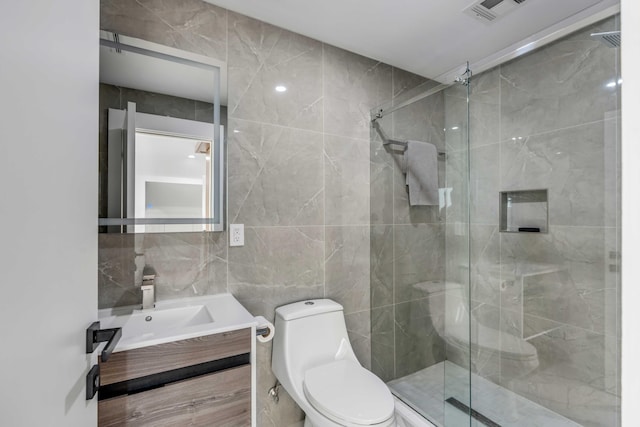 bathroom with walk in shower, vanity, toilet, and tile walls