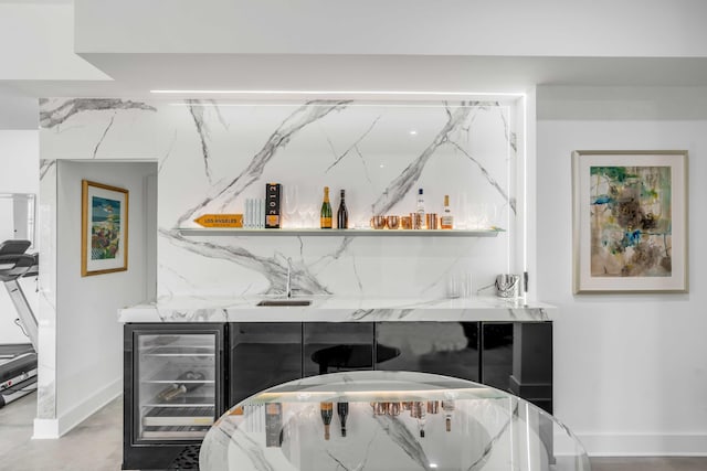 bar featuring wine cooler and light stone counters