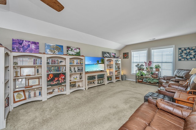 living room featuring ceiling fan, carpet floors, and lofted ceiling