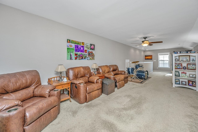 carpeted living room with ceiling fan and vaulted ceiling