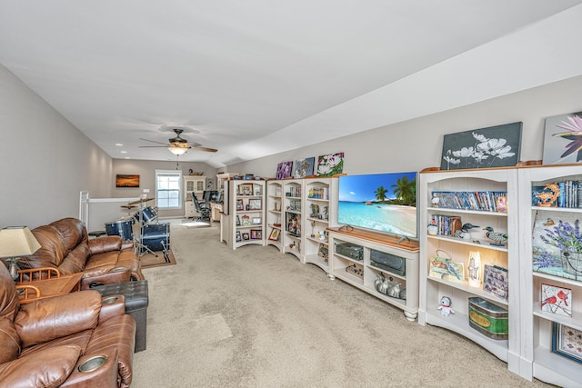 carpeted living room with ceiling fan and lofted ceiling