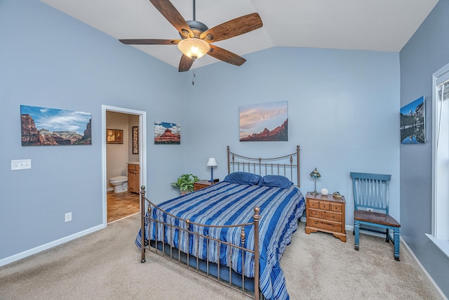 bedroom with carpet floors, ensuite bathroom, vaulted ceiling, and ceiling fan