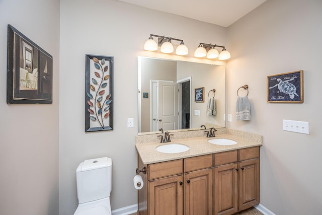 bathroom featuring vanity and toilet