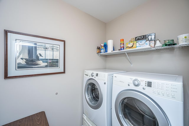 clothes washing area featuring washer and clothes dryer