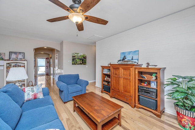 living room with ceiling fan and light hardwood / wood-style flooring