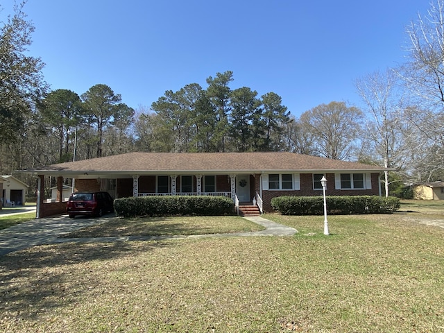 ranch-style home with a front yard and a carport