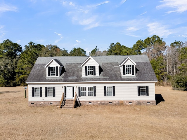 cape cod-style house with a front yard