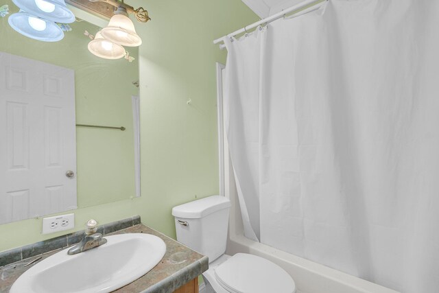 full bathroom with vanity, toilet, and shower / bath combo with shower curtain