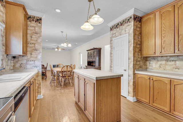 kitchen with dishwasher, sink, hanging light fixtures, ornamental molding, and a center island